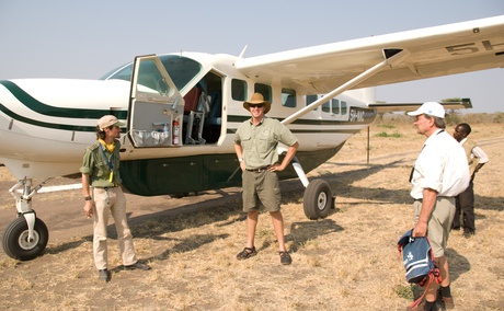 Passengers boarding a shared charter flight with Safari Air Link on a Cessna Caravan